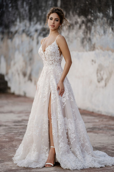 outdoor photo of woman wearing white allure couture designer wedding dress