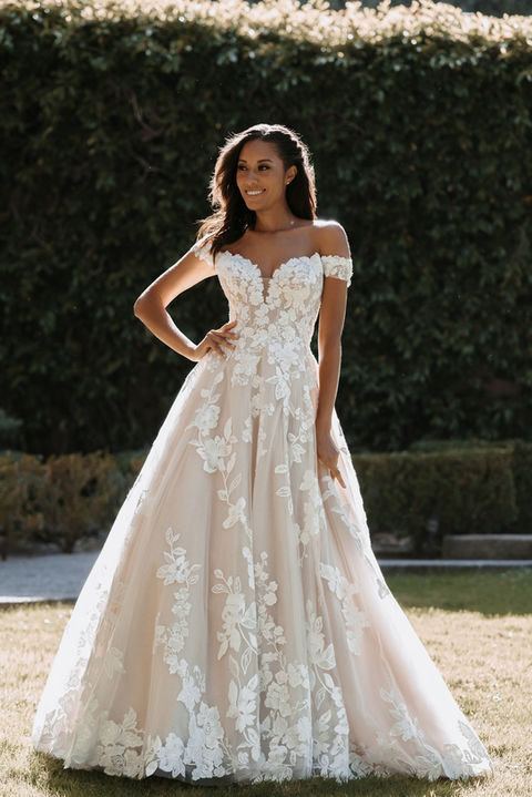 outdoor photo of woman wearing white allure couture designer wedding dress