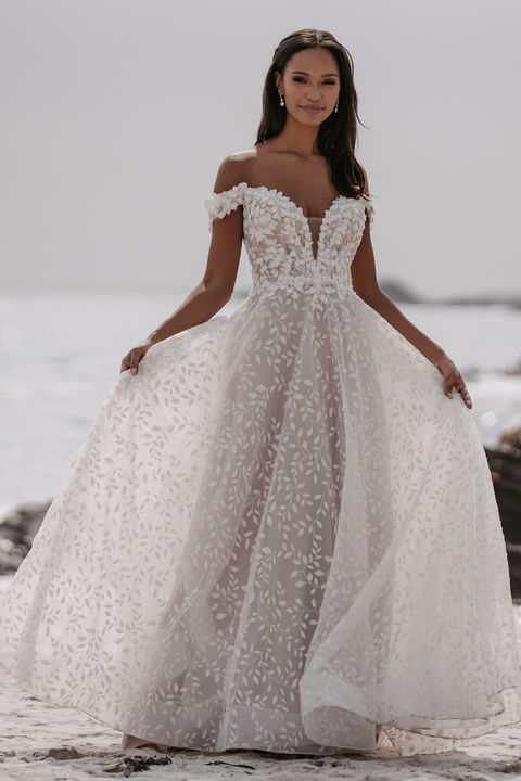 outdoor photo of woman wearing white allure couture designer wedding dress