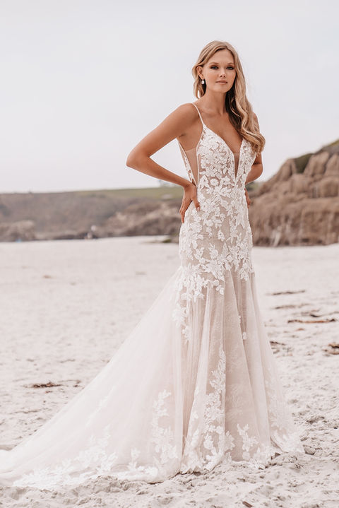 outdoor photo of woman wearing white allure couture designer wedding dress