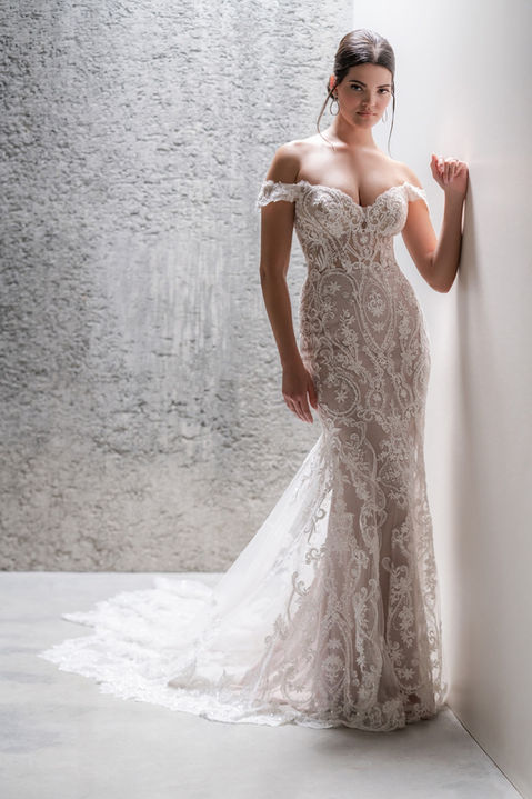 indoor photo of woman wearing white allure couture designer wedding dress