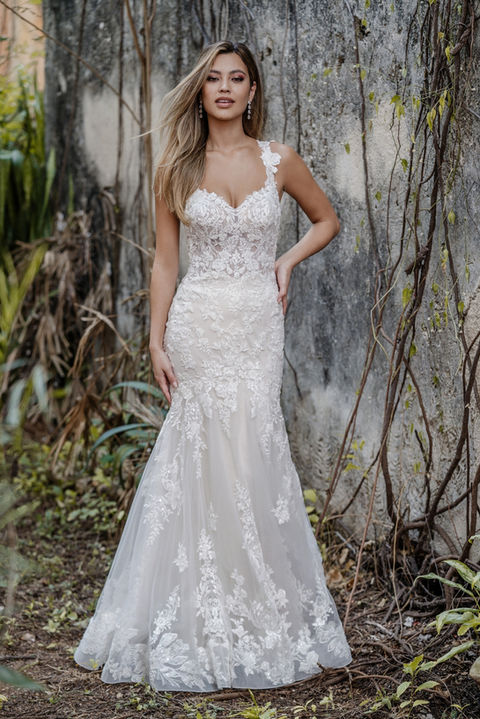 outdoor photo of woman wearing white allure couture designer wedding dress