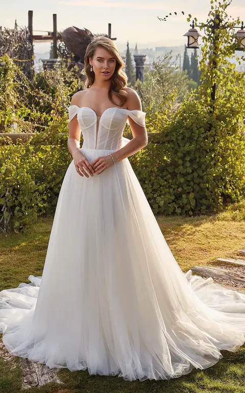 outdoor photo of woman wearing white designer eddy k wedding dress