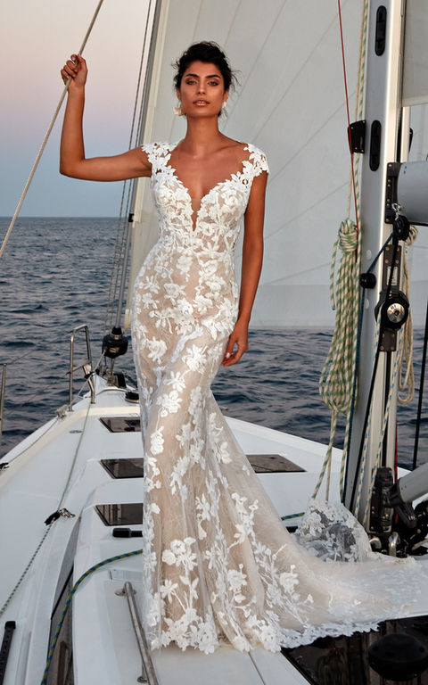 boat photo of woman wearing white designer eddy k wedding dress