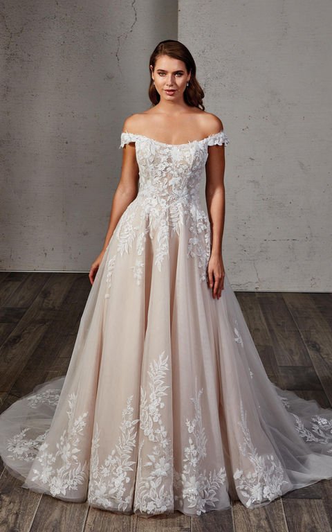 indoor photo of woman wearing white designer eddy k wedding dress