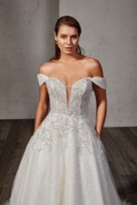 indoor photo of woman wearing white designer eddy k wedding dress
