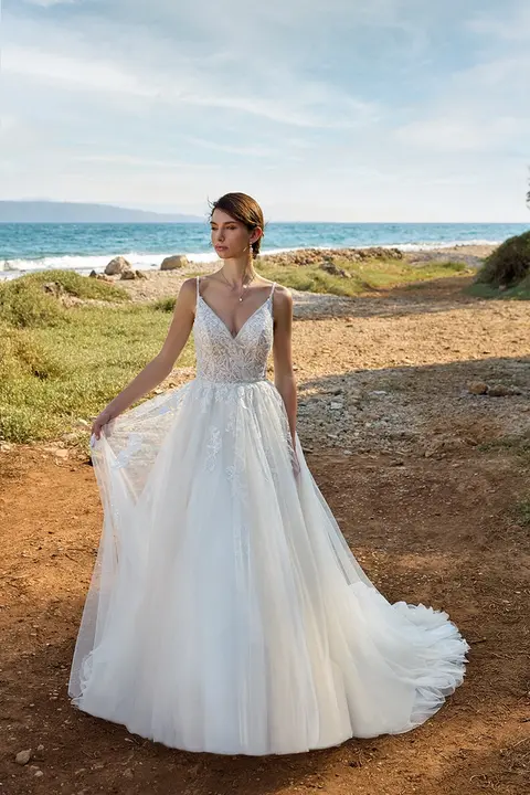 outdoor photo of woman wearing white designer eddy k wedding dress