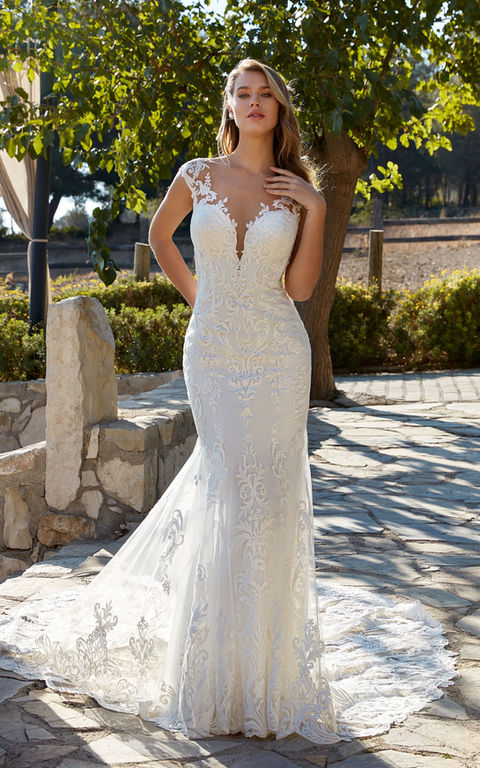 outdoor photo of woman wearing white designer eddy k wedding dress