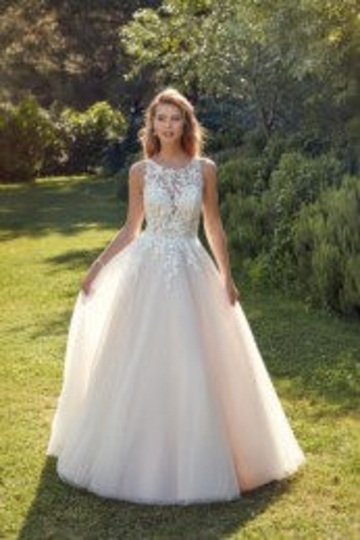 outdoor photo of woman wearing white designer eddy k wedding dress
