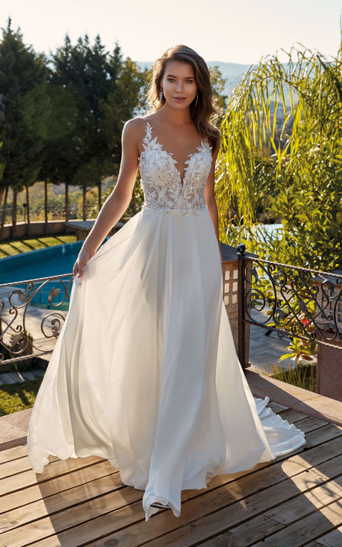 outdoor photo of woman wearing white designer eddy k wedding dress