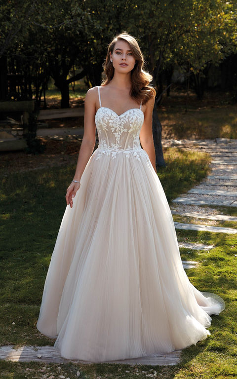 outdoor photo of woman wearing white designer eddy k wedding dress