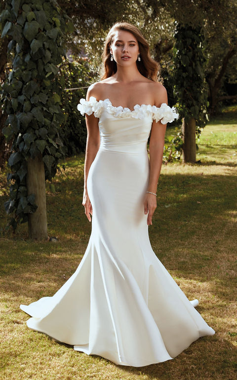 outdoor photo of woman wearing white designer eddy k wedding dress