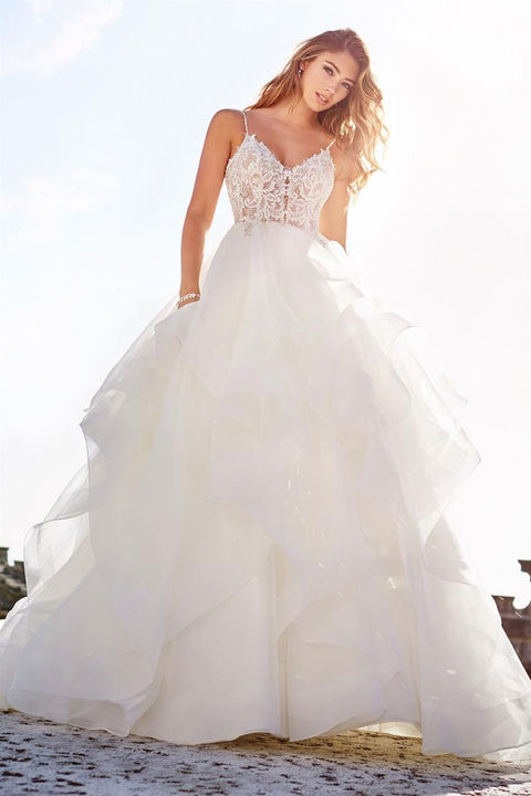 outdoor photo of woman wearing white martin thornburg designer wedding dress