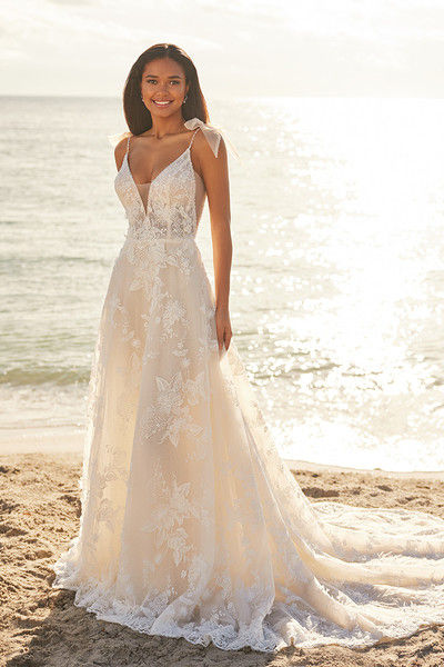 outdoor photo of woman wearing white martin thornburg designer wedding dress