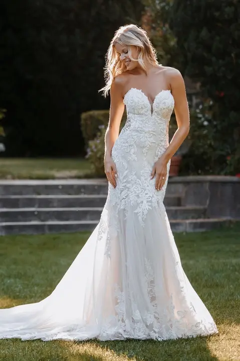 outdoor photo of woman wearing white martin thornburg designer wedding dress