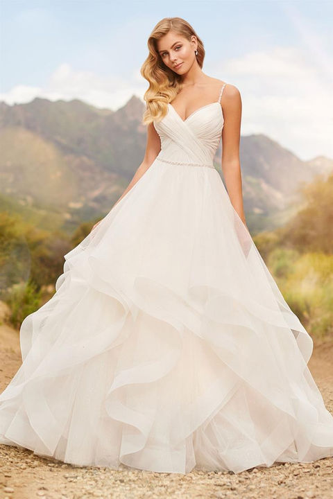outdoor photo of woman wearing white martin thornburg designer wedding dress