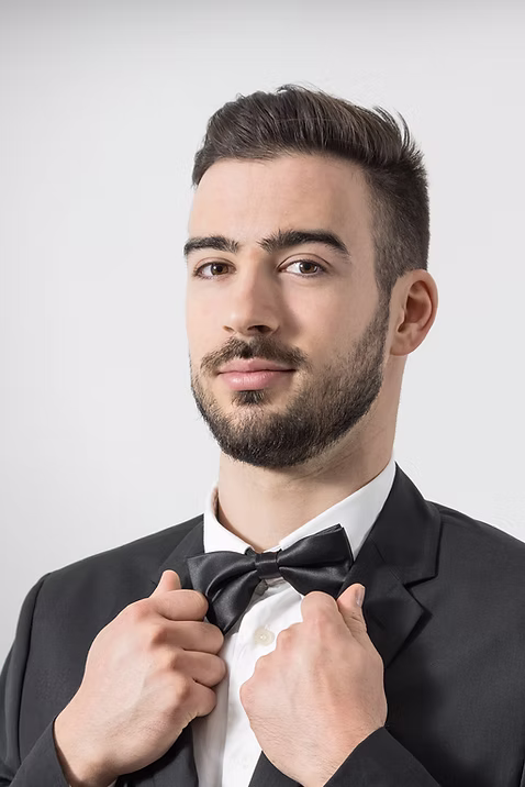 indoor photo of man in designer black tuxedo
