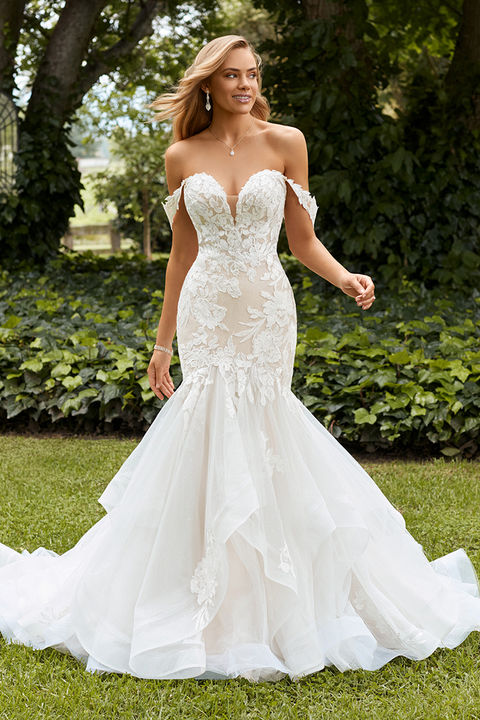 outdoor photo of woman wearing white designer sophia tolli wedding dress