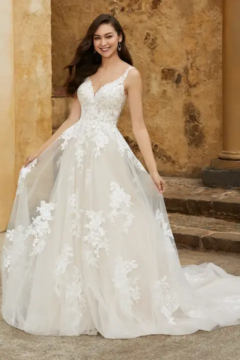indoor photo of woman wearing white sophia tolli designer wedding dress