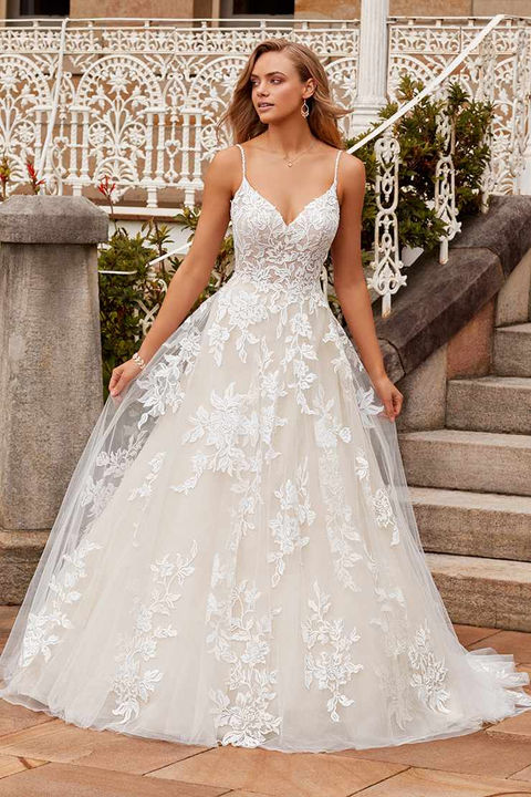 outdoor photo of woman wearing white designer sophia tolli wedding dress