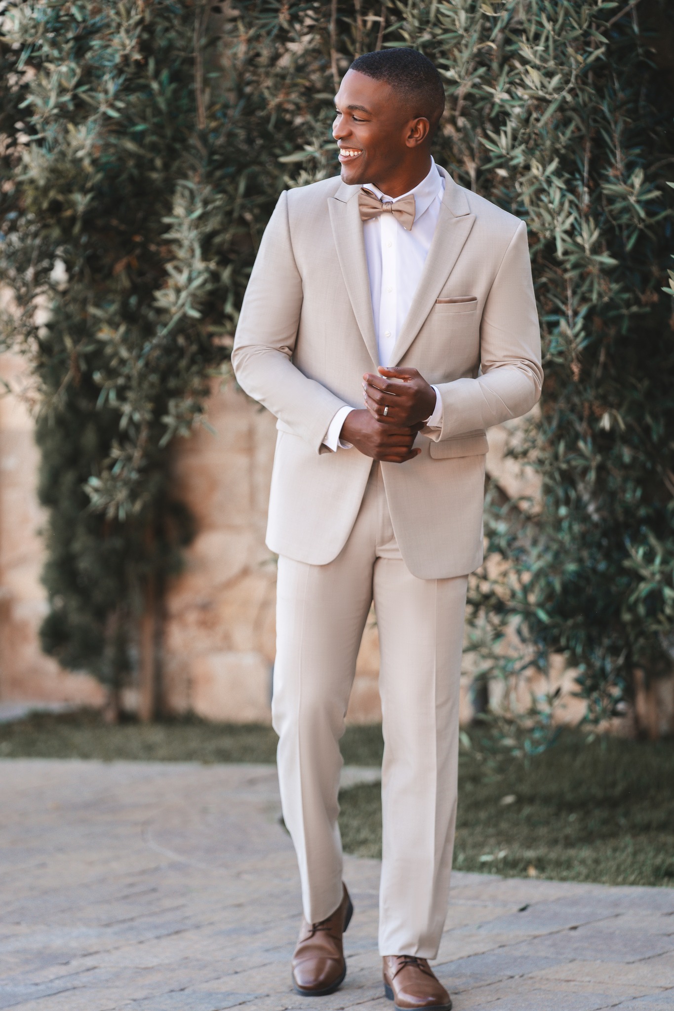 man wearing sand colored bunny's rental tuxedo outdoors