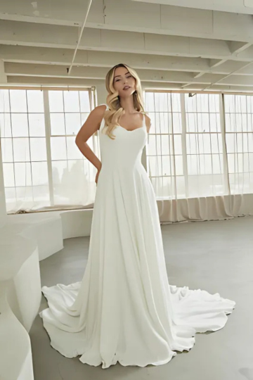 woman wearing designer madi lane wedding dress indoors